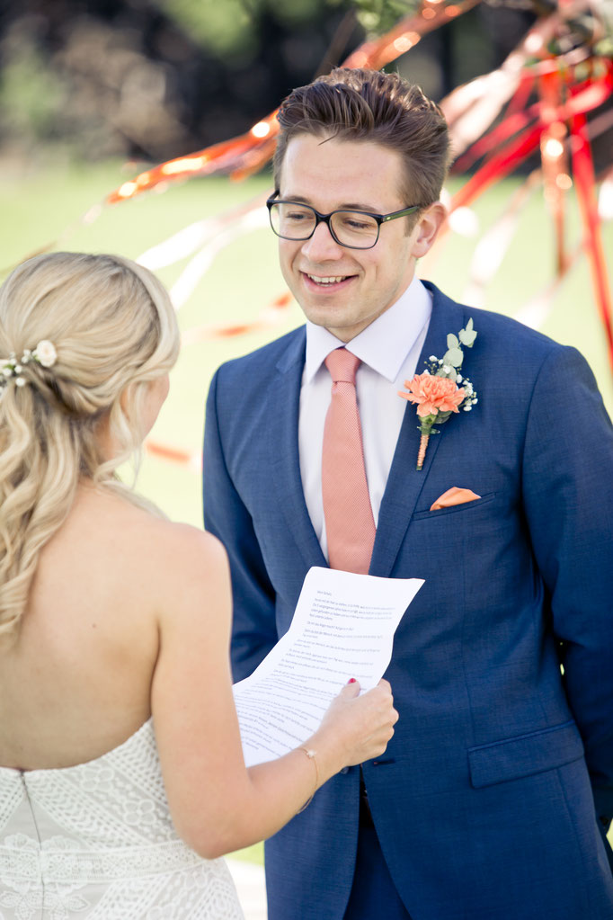 Bräutigam lächelt während dem Eheversprechen seiner Braut