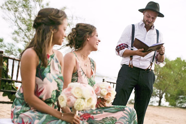 Wedding celebrant speaking beside the bride and a guest
