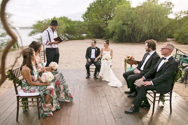 Bride and groom listening to their wedding celebrant