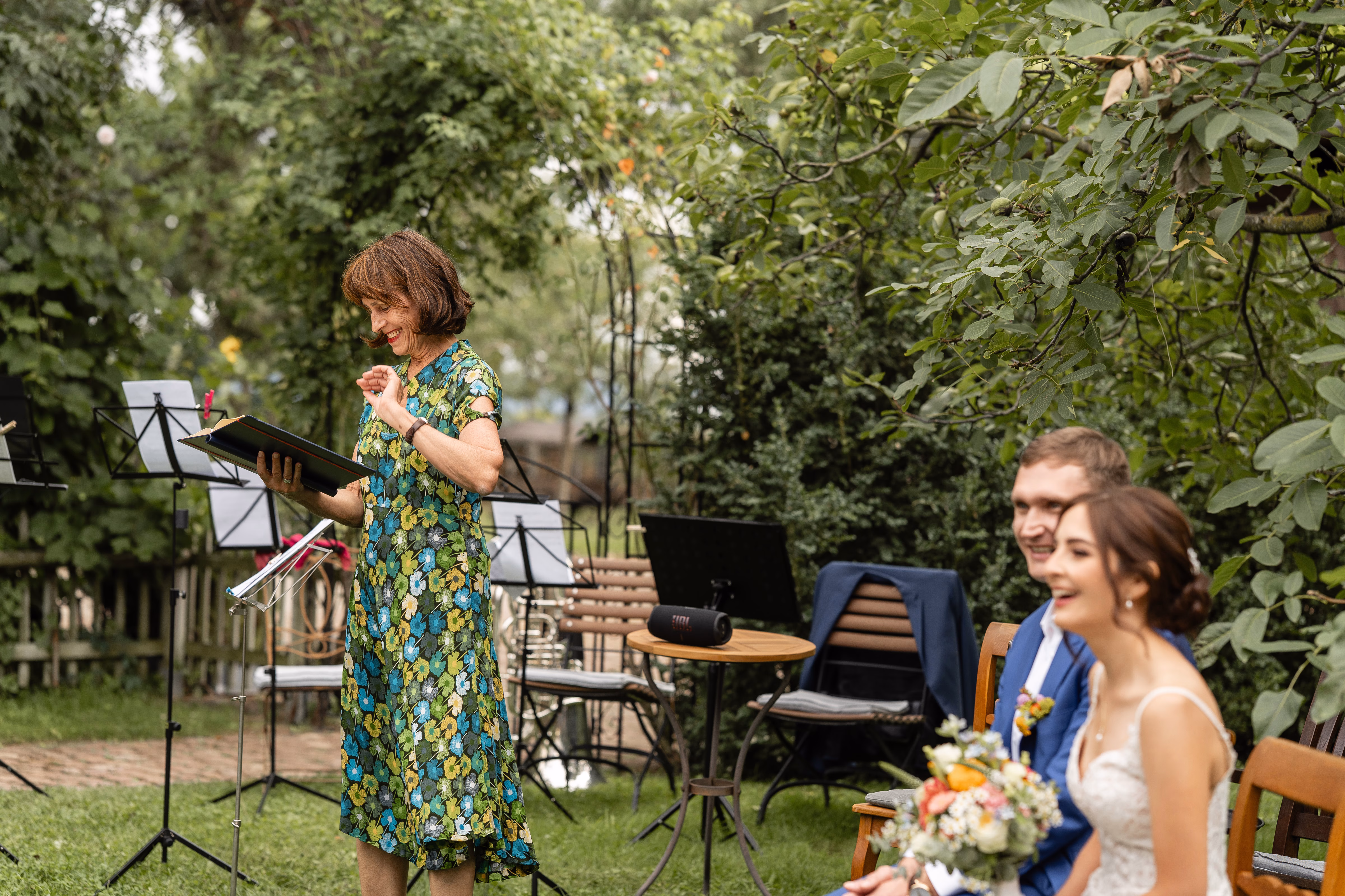 Wedding celebrant Carola Trenkle with a couple during an outdoor ceremony
